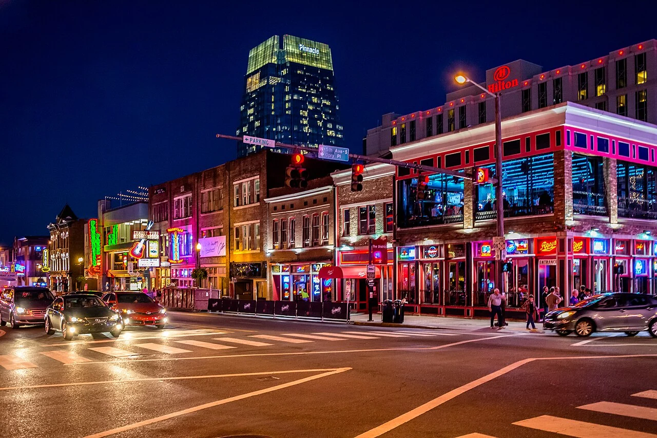 Neon honky-tonk signs along Lower Broadway in Nashville at night.